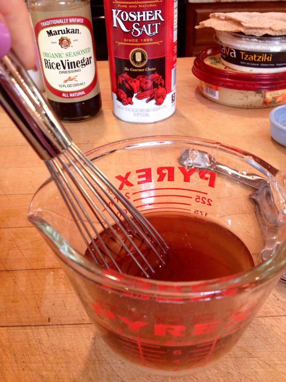 Whisk together the vinegar, sugar, and salt in a liquid measuring cup until the sugar has dissolved.