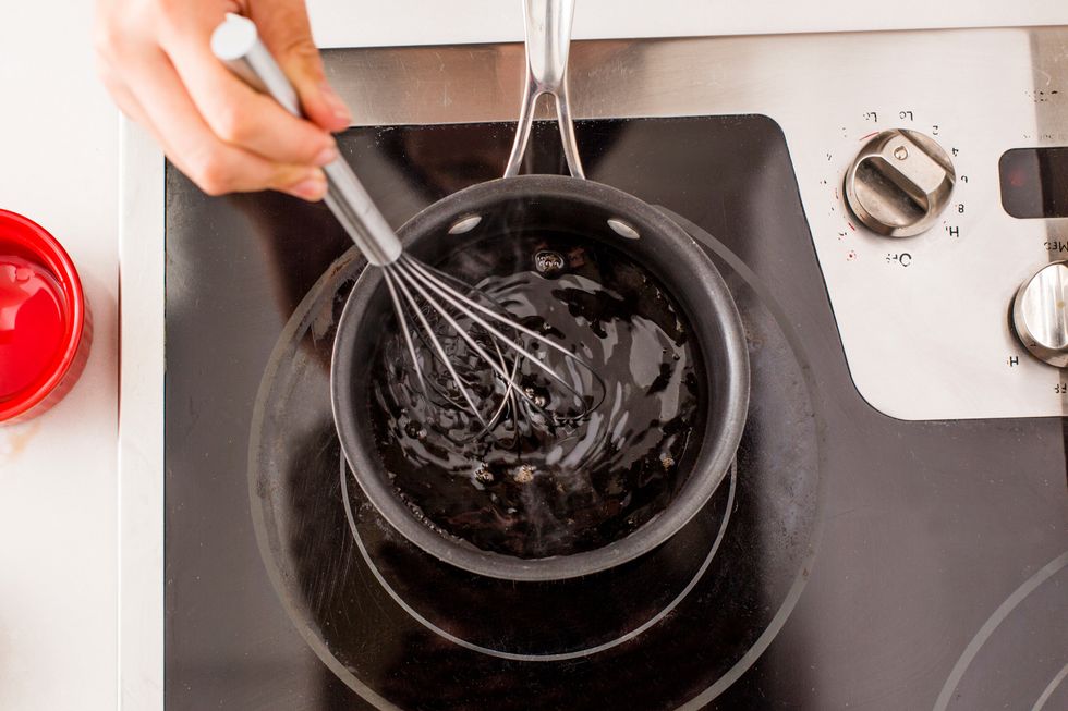 Whisk \u00bd cup balsamic vinegar and two tablespoons honey in a small sauce pan over high heat.