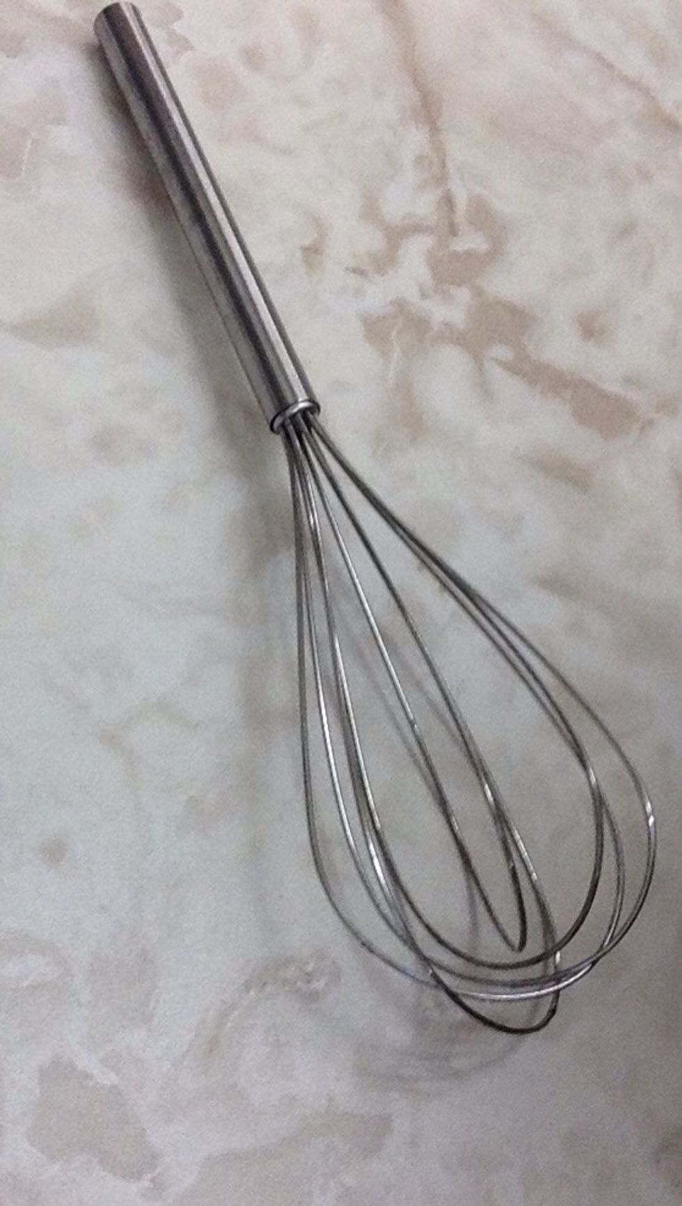 Whisk. Used for whipping/mixing ingredients, such as mixing cake batter. I can use a whisk when mixing cupcake batter.
