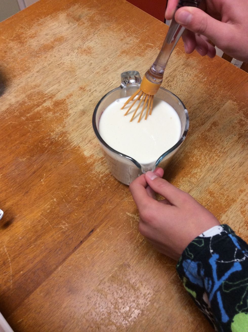 Whisking milk, egg, coconut milk and vanilla essence