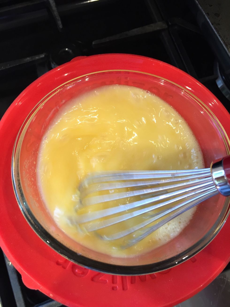 Whist everything together and heat over the water for 10-15 minutes until it thickens