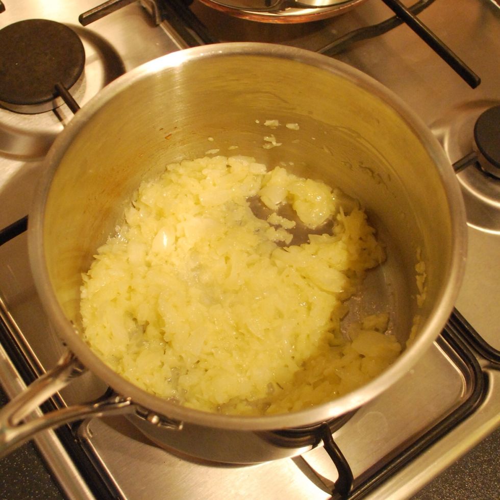 Whizz up or finely chop the onion and rest of garlic. Melt the butter and oil in a big pan, the biggest you have and then gently fry off the onion and garlic until soft and golden. Don't burn!