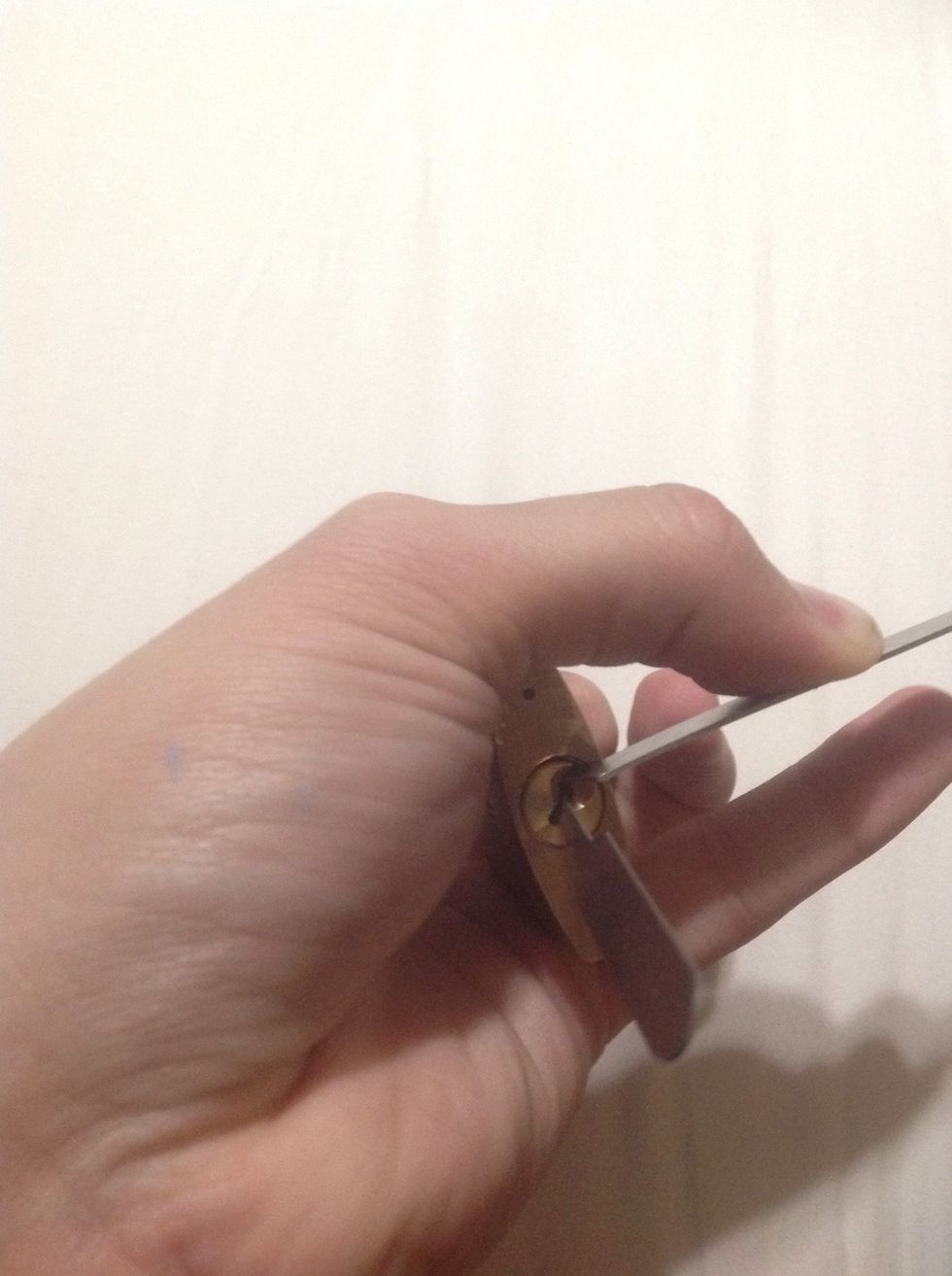 Wiggle the pick over each of the pins starting from the far back of the lock. (Farthest from you.) Repeat this step until the lock releases and unlocks. You should hear a slight click when done right.