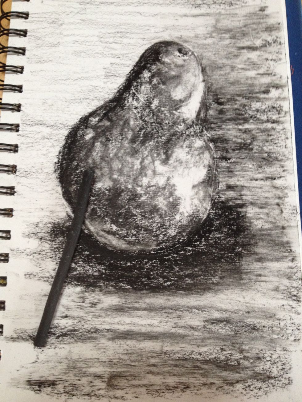 Willow or vine charcoal is even softer than the 4B. I used it to soften transitions of the pear and to bring back some wood grain to the table. This only works if I use the eraser first. No outlines!