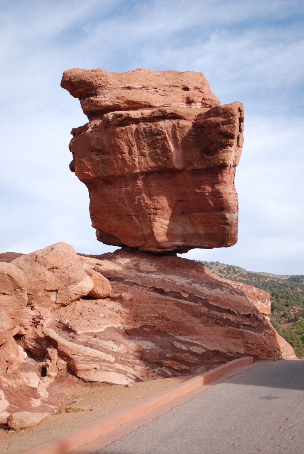Wind and rain weathers the rock away over millions of years (weathering)