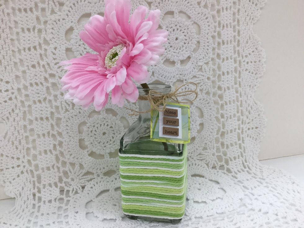 Wind both ends of the twine around the neck of the bottle and finish with a bow. Add a beautiful flower and decide...will you keep it for yourself or give it to someone special?