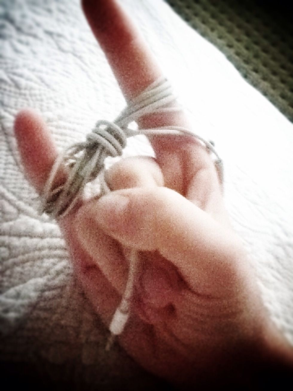 Wind this section of wire under and around the middle of your figure eight until you have about an inch and a half left.