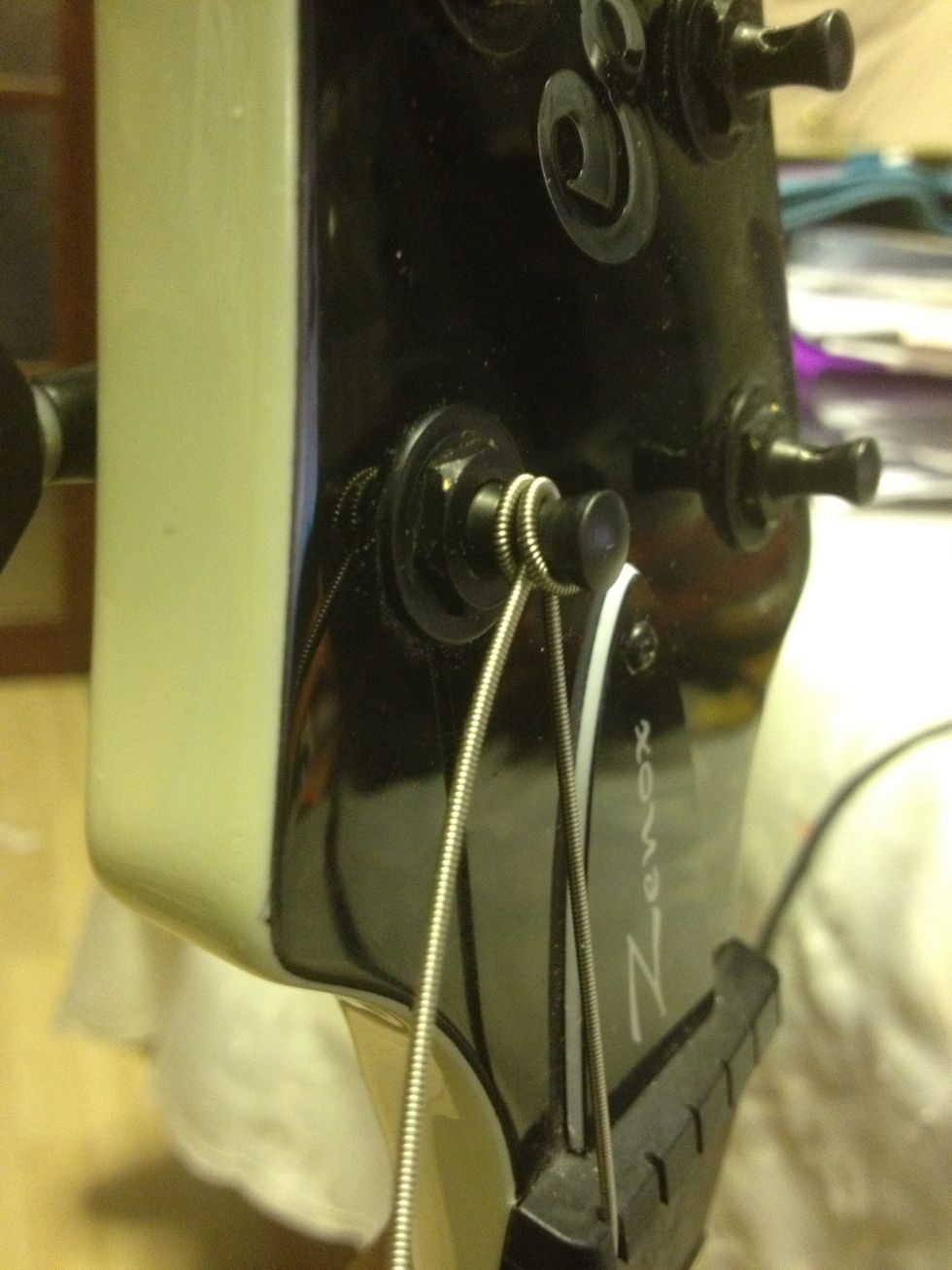 Wind until it is in tune (can use a tuner at this point but doesn't have to be accurate). Once in tune, wind the string three turns higher. This will stretch the string for you