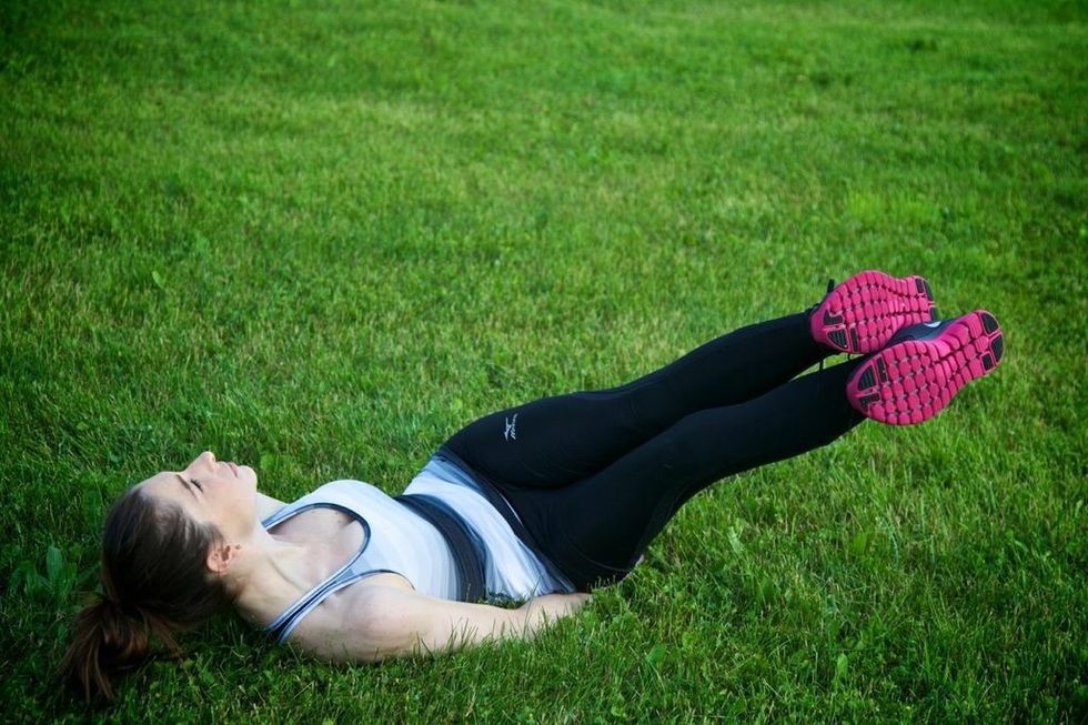 WINDSHIELD WIPERS: That is one rep. Complete twelve reps, total. For an advanced workout, contract your abs and lift your bum off the ground when you return to starting position.