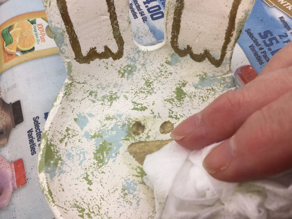Wipe off any paint that stuck to the gold embossed areas with a baby wipe or wet paper towel.