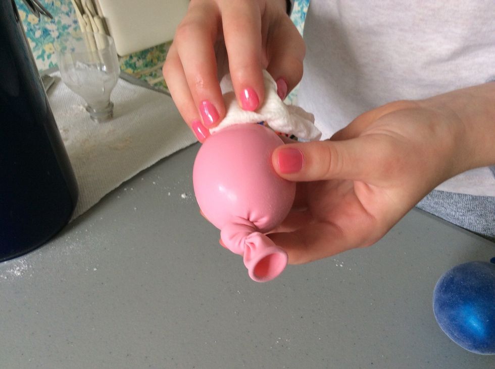 Wipe the flour off the outside of the balloon