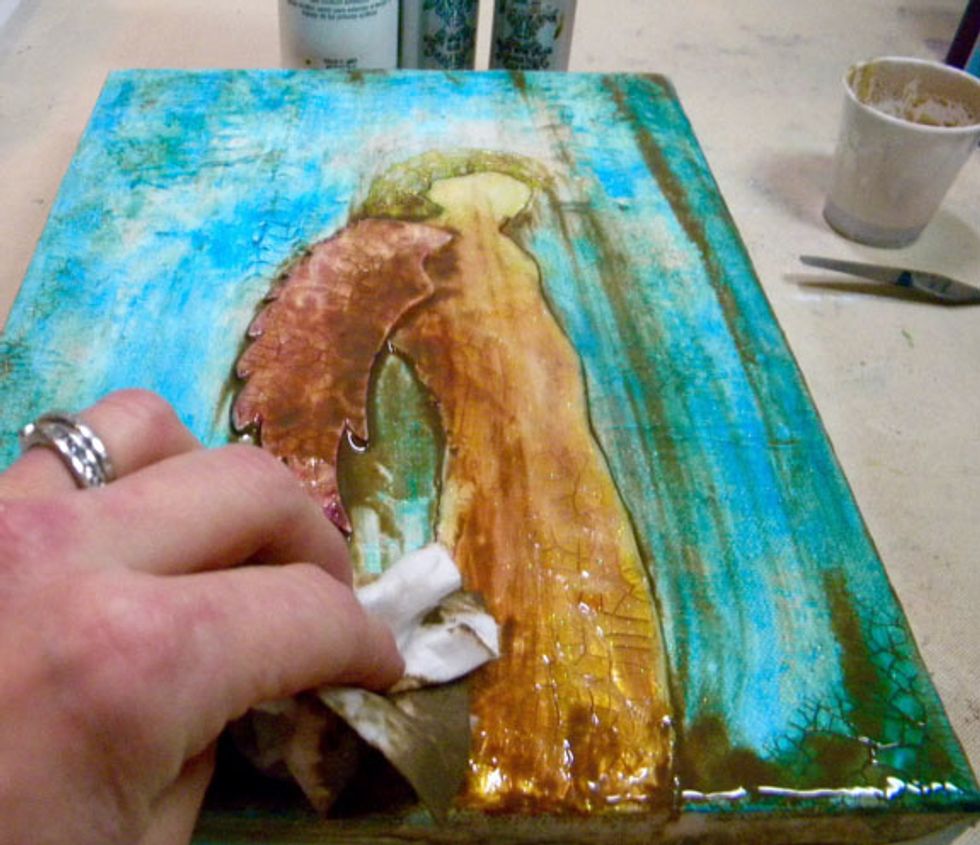 Wipe the glaze off using a baby wipe or soft cloth, leaving some around the angel's edges to create shadows. Repeat this process if needed.