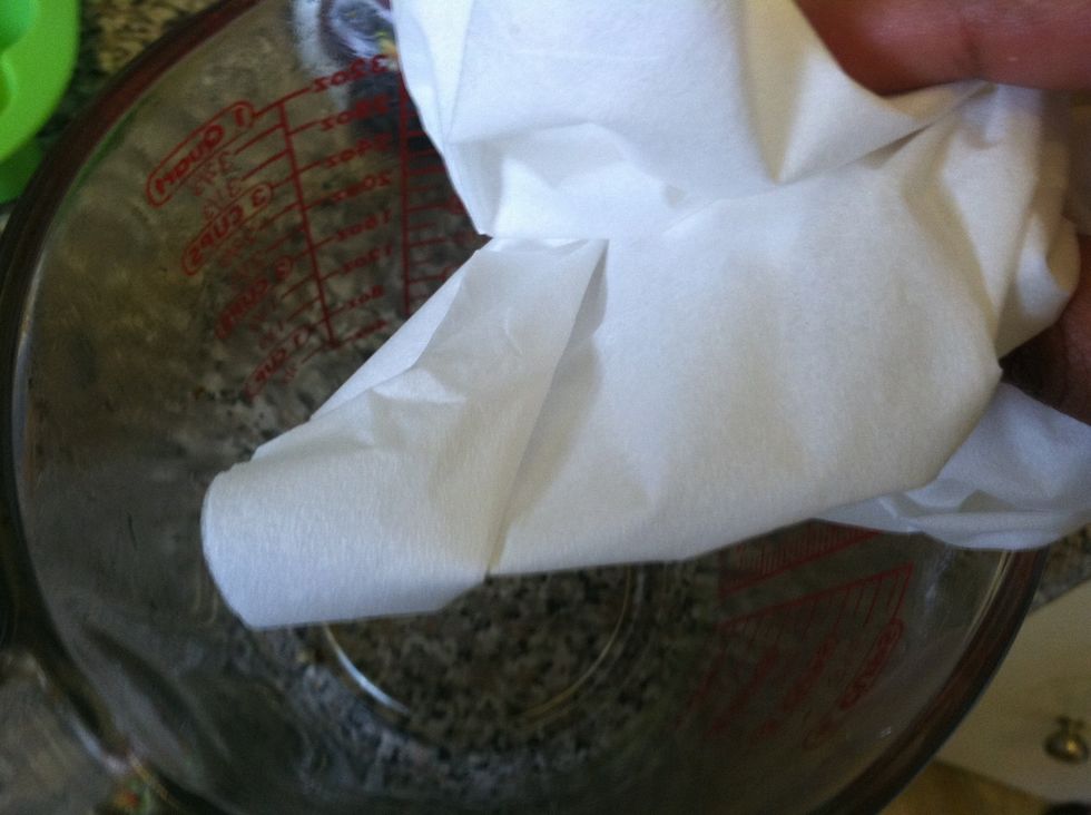 Wipe the measuring cup with a napkin, paper towel, or wash cloth while it still looks wet. It makes it a million times easier to clean.