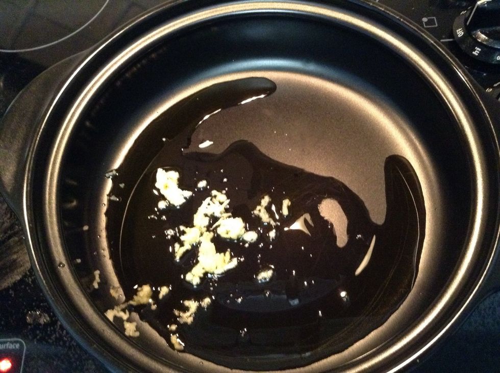 With 1 Tbsp Olive oil into your soup pot over medium heat. Add your minced garlic. Don't burn, have all your ingredients ready to get into the pot one after another at this point.