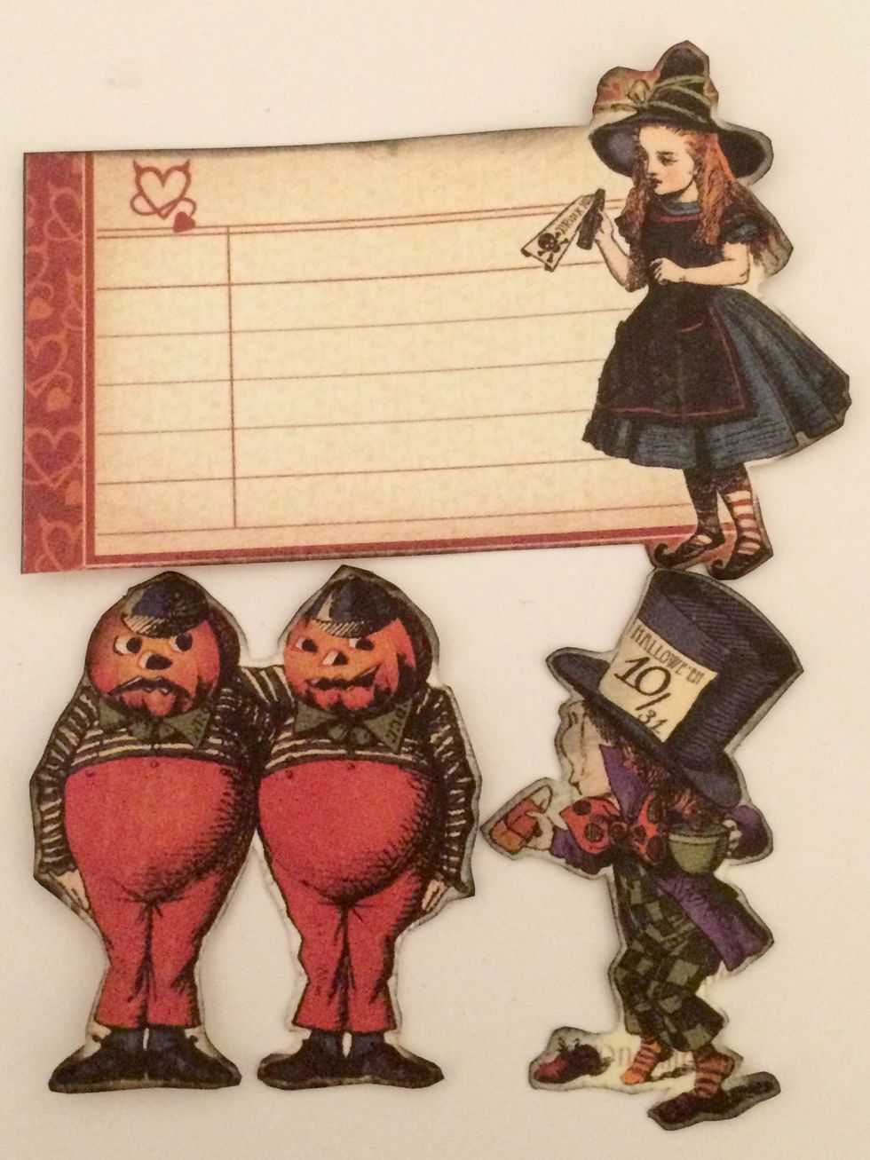 With a blending tool and Black Soot Distress Ink, ink the edges of the Mad Hatter, Alice tag and Tweedledee & Tweedledum.