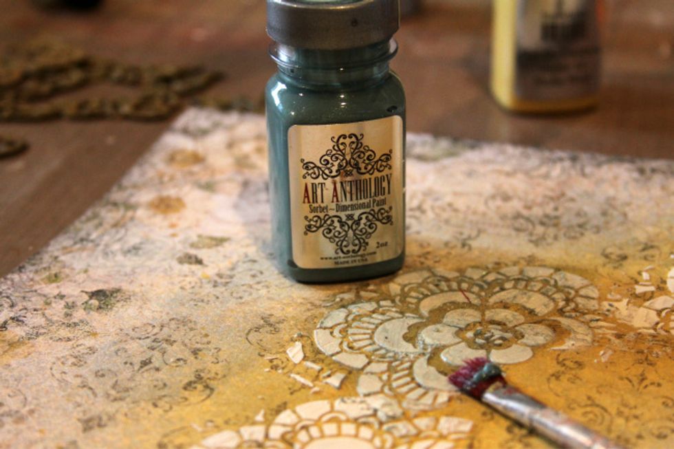 With a brush paint the top of your stenciled modeling paste with Sorbet - Mint Julep.