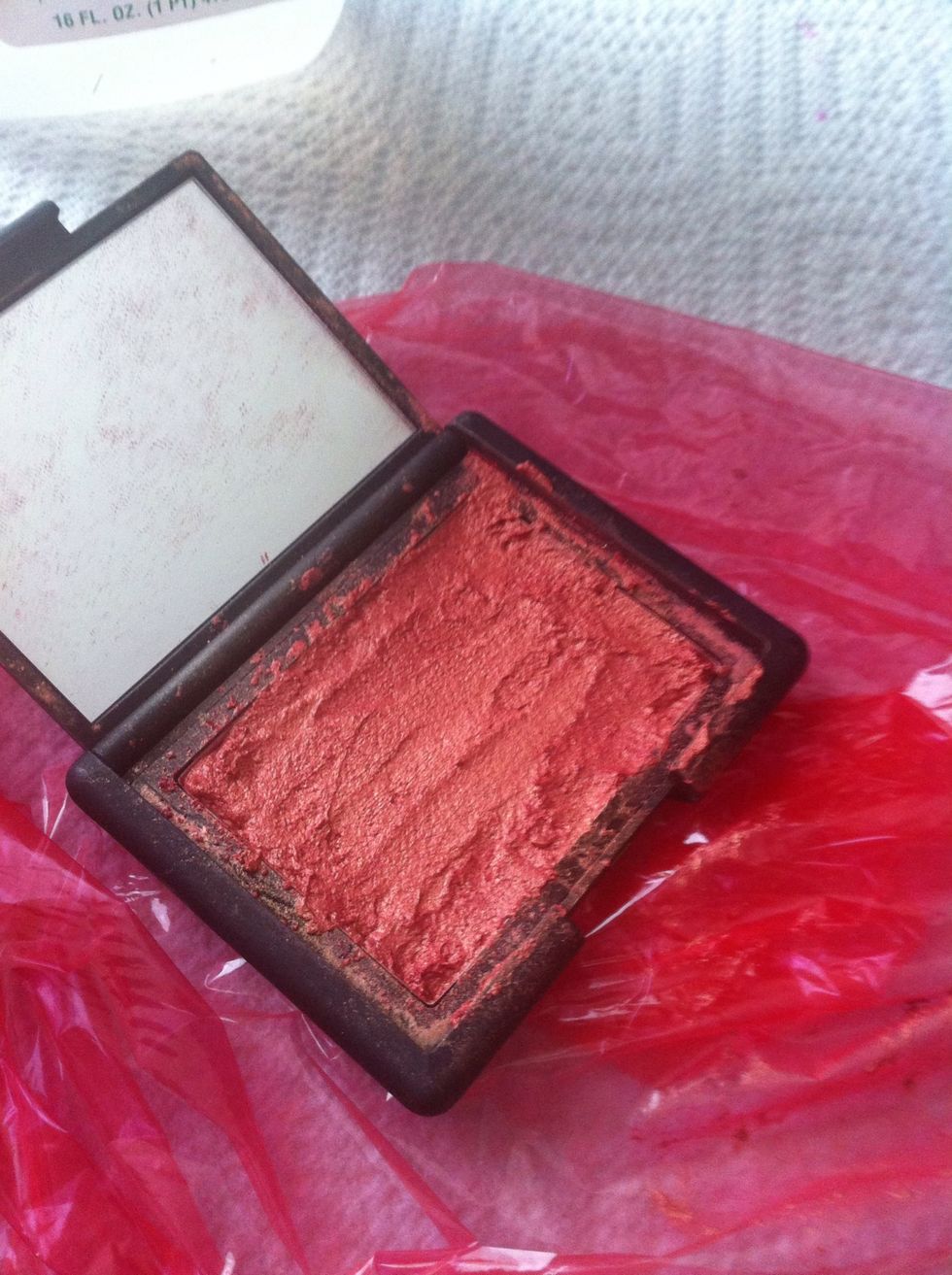 With a clean finger (you don't want your oils messing up your blush) lightly smooth out the mixture as best as you can. Don't worry if its not perfect. MAKE SURE YOU REACH ALL EDGES OF THE PAN!