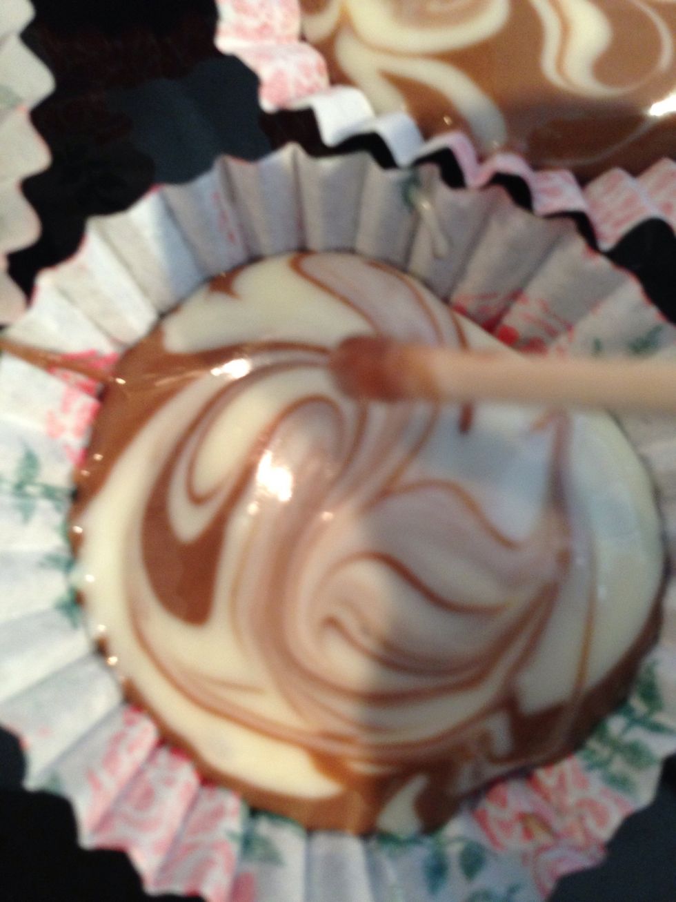 With a cocktail stick gently mix the chocolate together to create a swirled marble effect