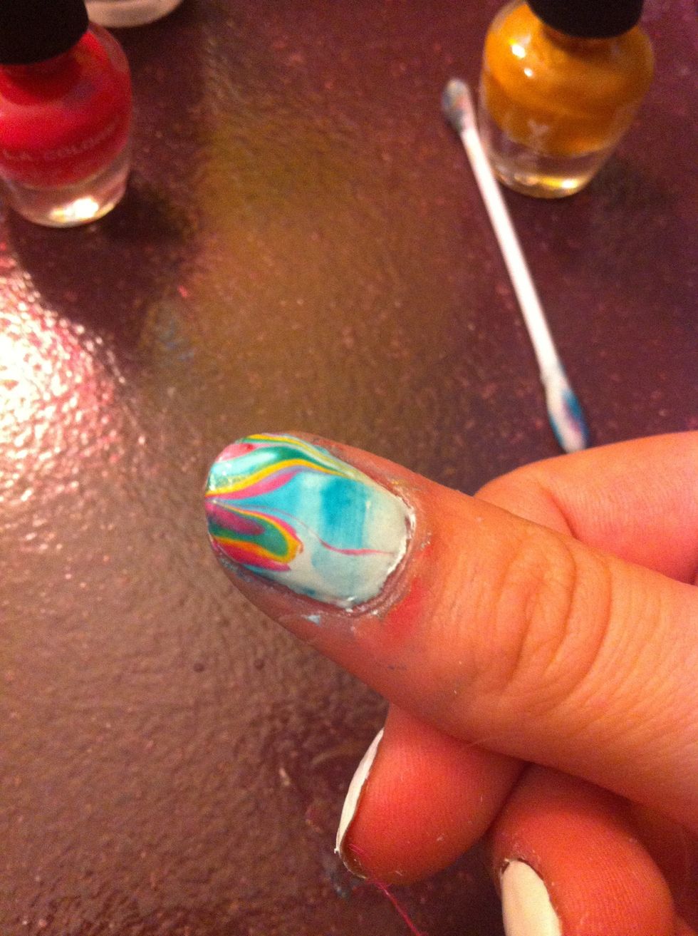 With a cotton swab and nail polish, take off the nail polish around your finger nail