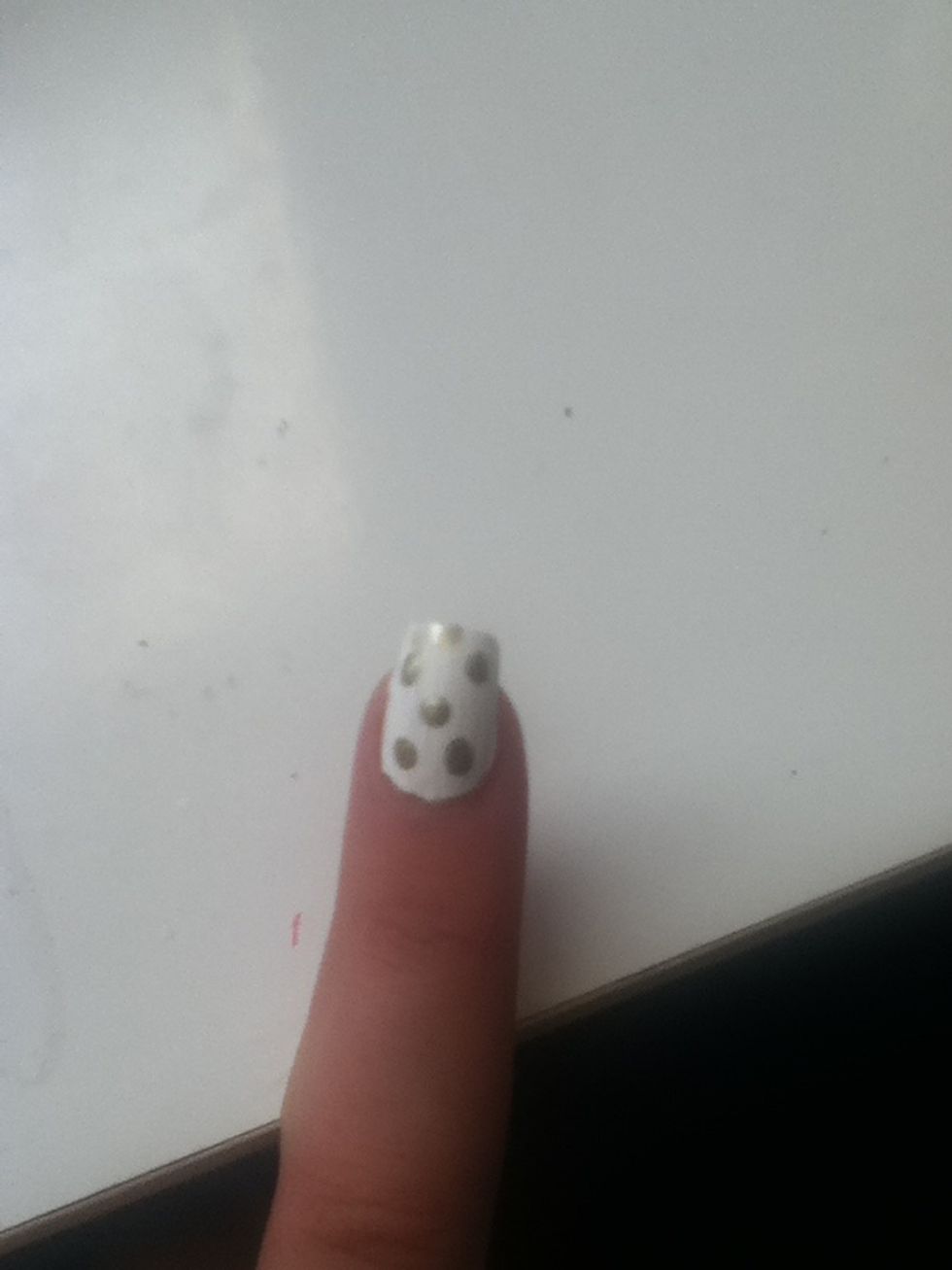 With a dotting tool or toothpick, make big gold/brown dots on the nail.
