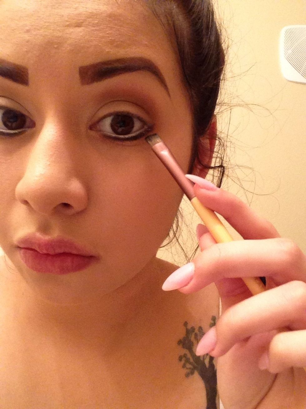 With a flat brush, put a line of black shadow beneath your waterline.