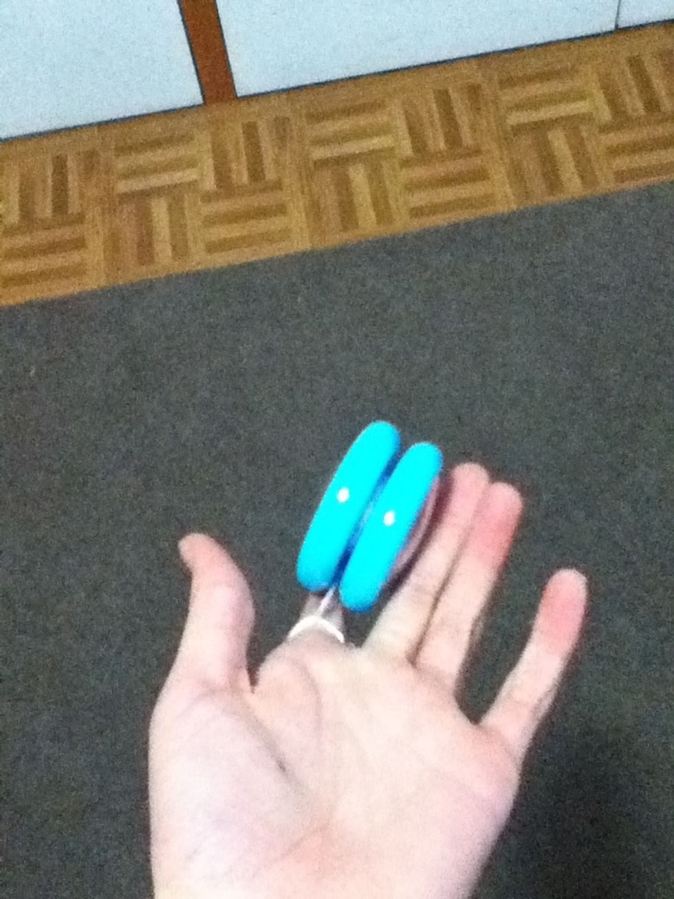 With a flick of your hand- Do this slowly if you are a beginner- roll the yoyo off your hand by keeping the ridge balanced on your finger.