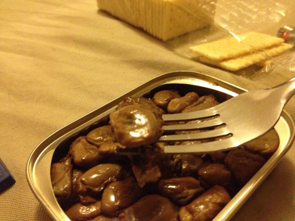 With a fork or your fingers, take a oyster and place it on a cracker.