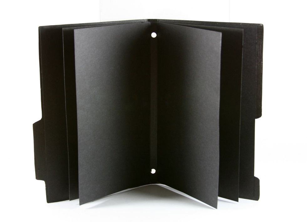 With a handheld cropodile punch with the larger hole on both sides. I didn't measure..I just slipped the pages in as far as it would go in the cropodile so they would be perfectly spaced.