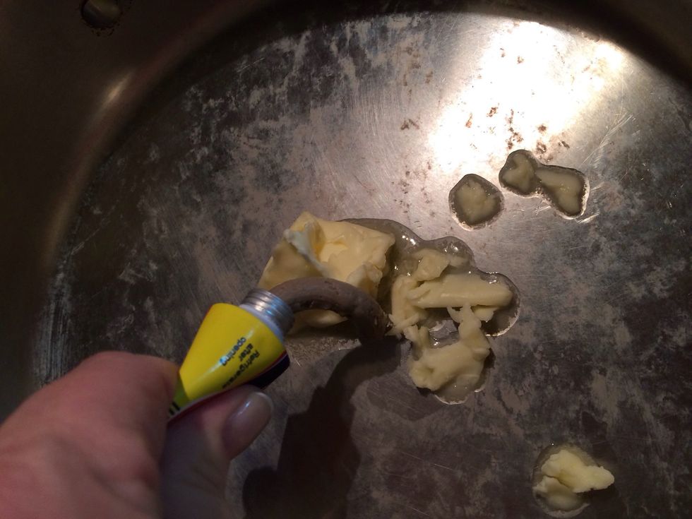 With a knob of butter. (A knob is about 2 T.)  Squeeze out about an inch of paste. Now you do not have to use this. But the flavor it adds is great!