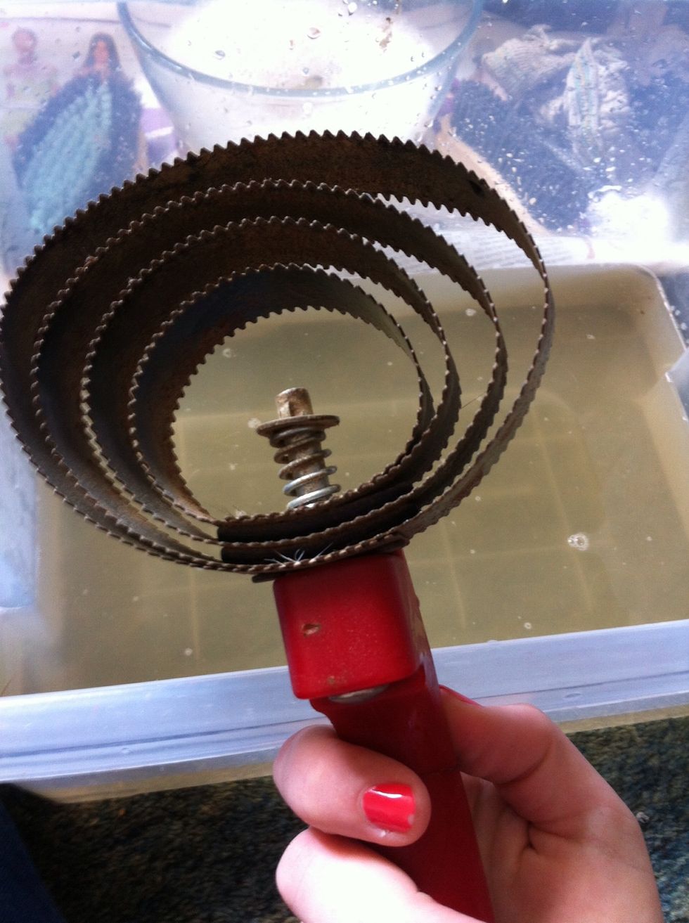 With a metal curry comb, get the toothbrush all the way round it. This is what you use to clean your other brushes so what is on them will be all over it. Dry it soon afterwards to avoid rusting