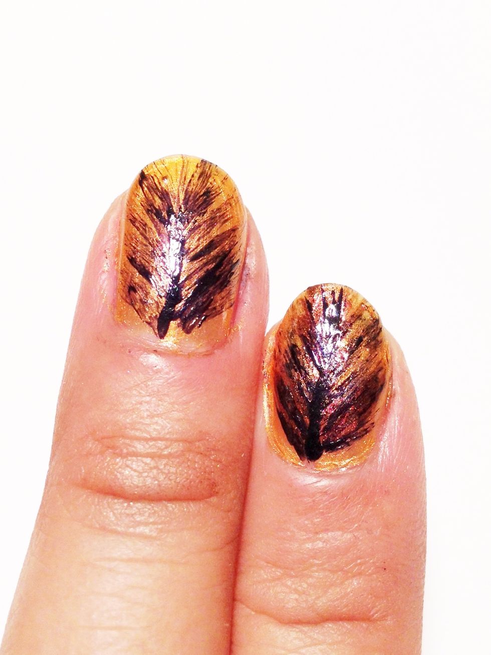 With a nail art brush dipped in black polish, create a vertical line. As you go upward create a quick stroke. Create short strokes outwards.