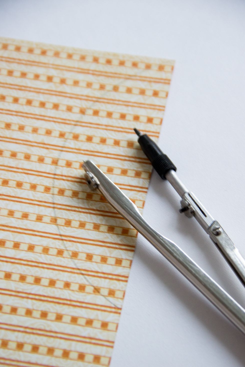 With a pair of compasses make a semicircle.