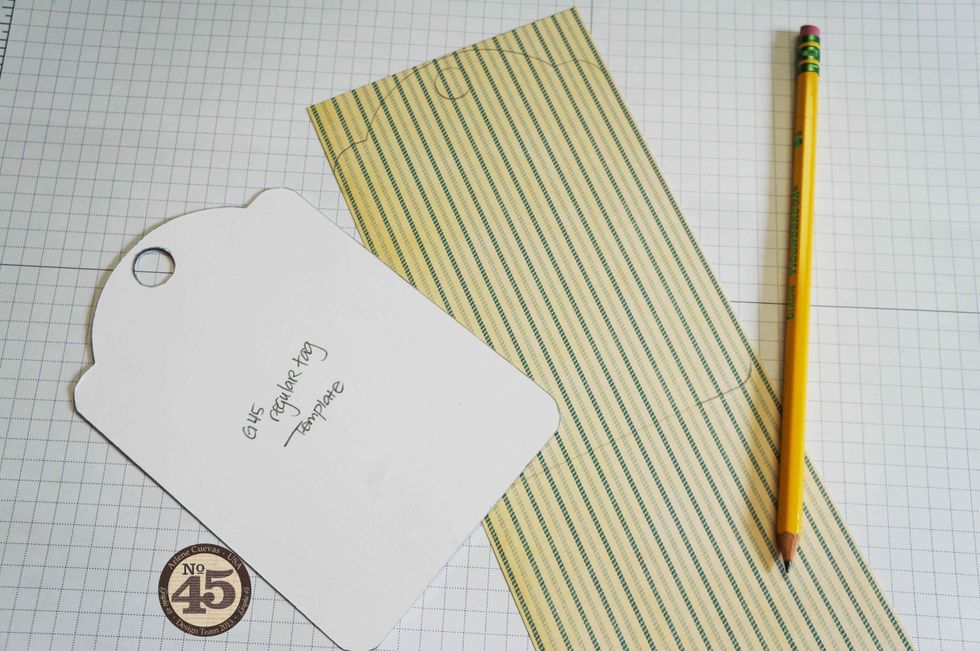 With a pencil, trace around the template on a piece of design paper as shown.