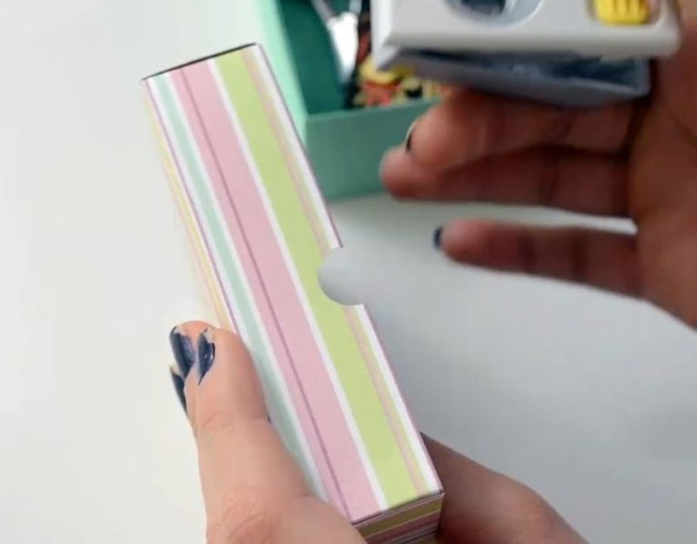 With a puncher, make 2 little holes on 2 opposite sides, like in image.