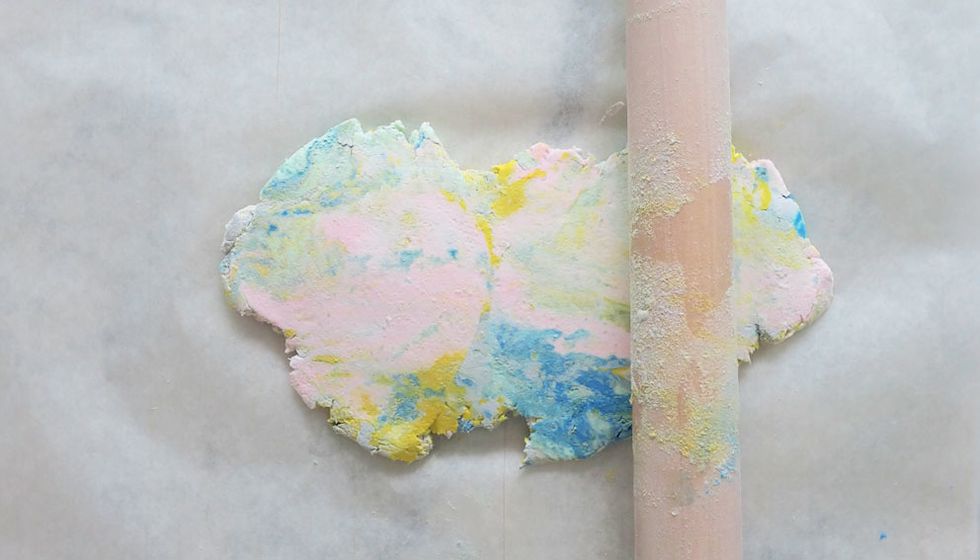 With a rolling pin, flatten out the dough. If you feel that areas look a little bland, you can always add in more coloured clay.