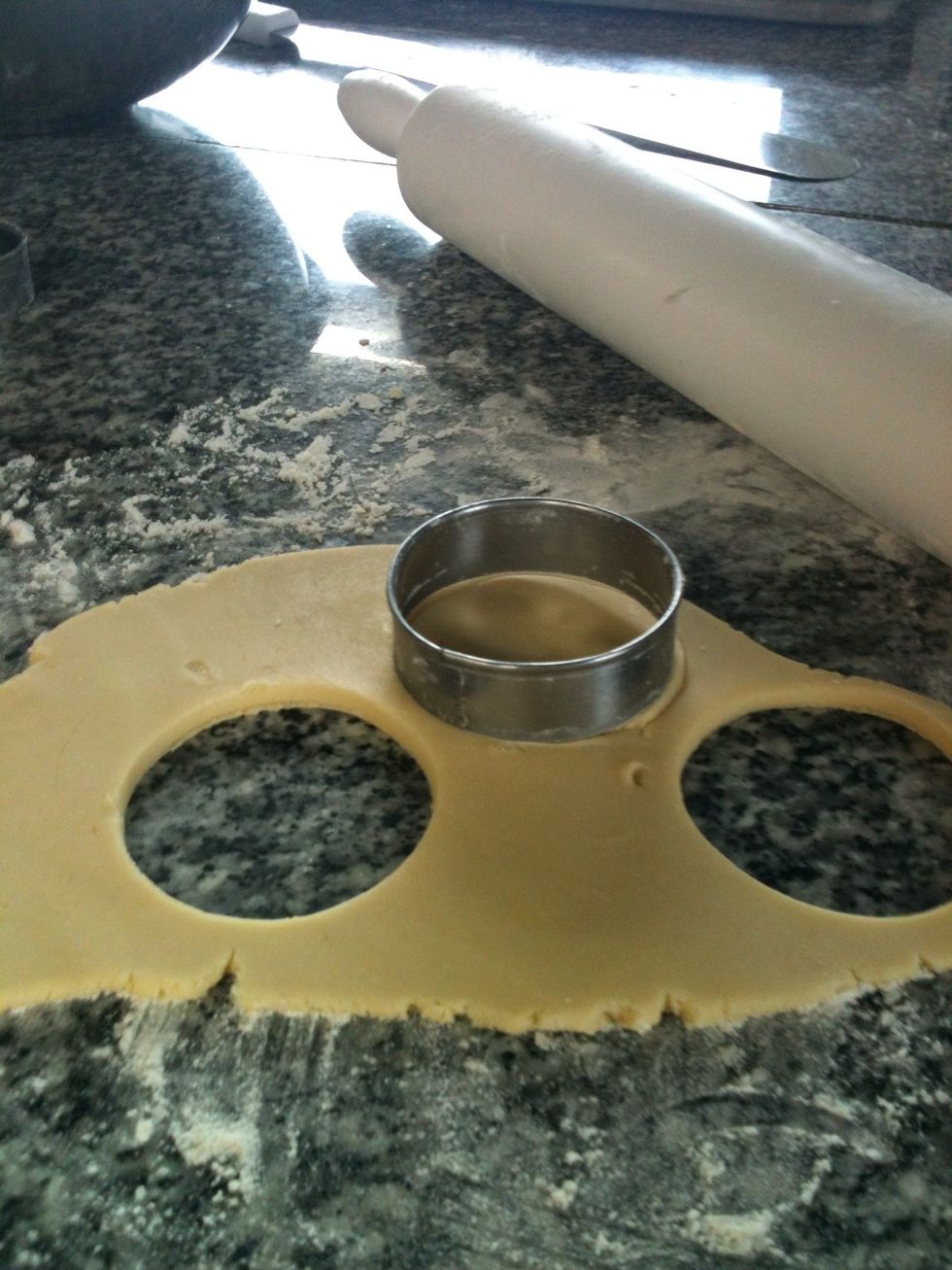 With a round cutter cut some cookies.