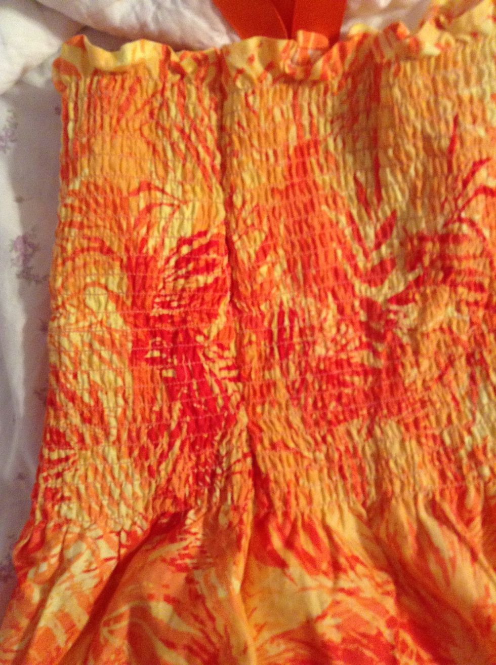 With a sewing machine, fold the fabric in half, inside out. Then stitch the entire thing into a strapless dress