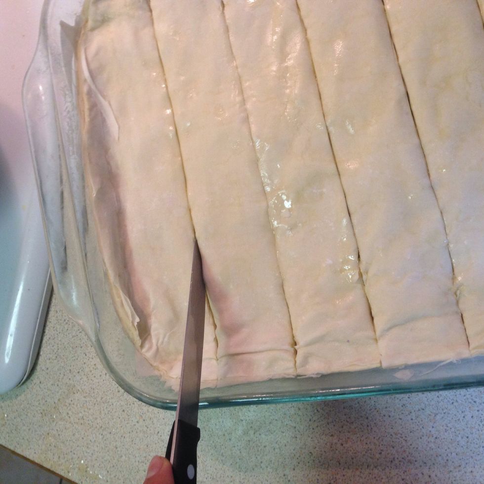 With a sharp knife, carefully cut straight lines from top to bottom, making sure to cut all the way down to the base of baking tray.