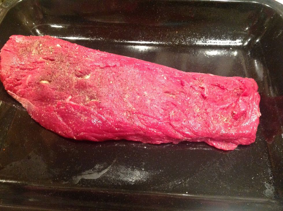 With a sharp knife, make incisions in the fillet and push the garlic slivers inside the flesh. Sprinkle with salt and pepper and place fillet on a greased oven dish.