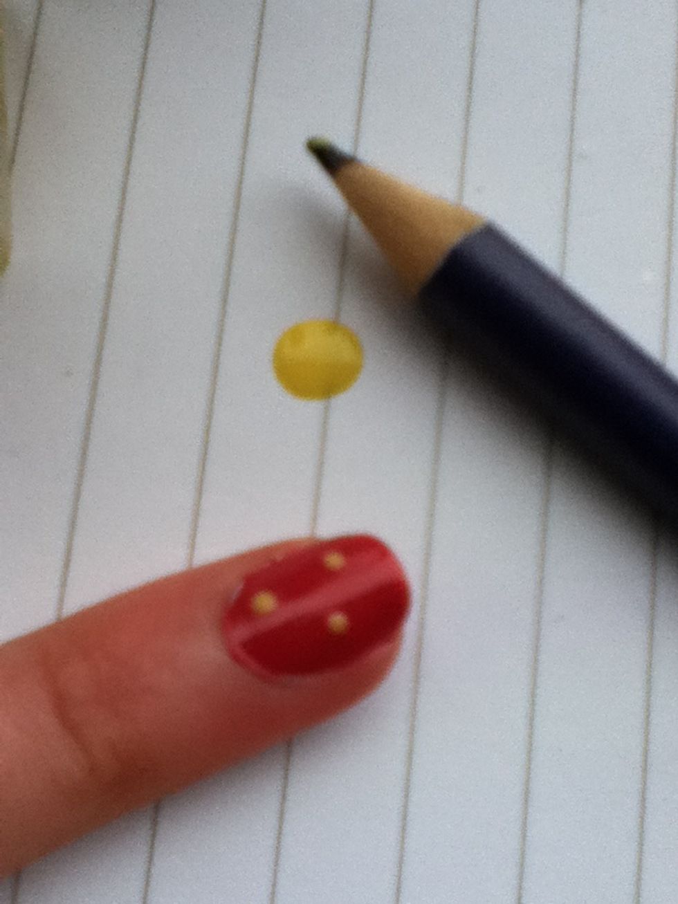 With a sharp pen or pencil, make three or four dots on the nail.