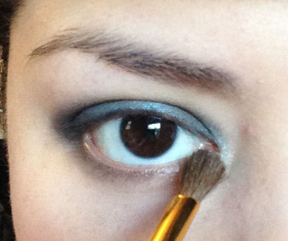 With a small brush I am taking the shade Silver (a metallic champagne silver color) and applying it just to my inner corner for a nice highlight.