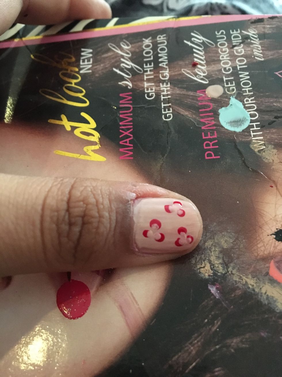 With a small dotting tool make three dots inside the red ones so the red dot now looks like a C. If you are confused, look at the video in the next step