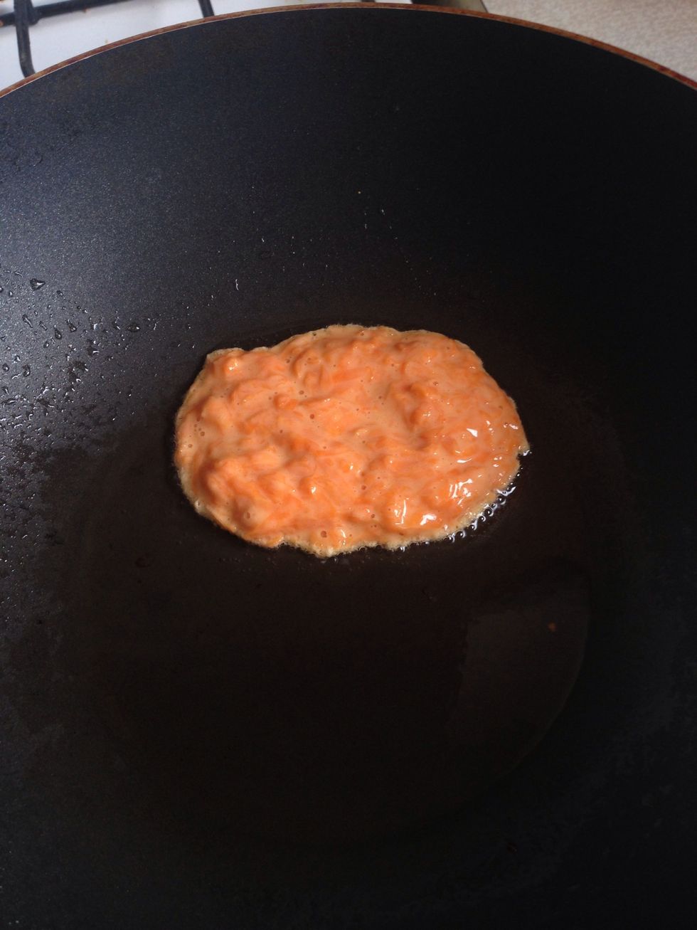 With a spoon, lay out the batter gently on a heated frying pan