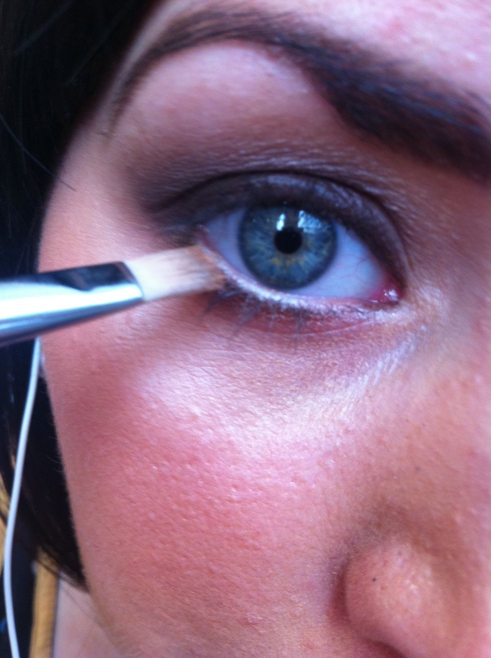With a synthetic flat brush take a pearly cream white eyeshadow and apply to your water line.