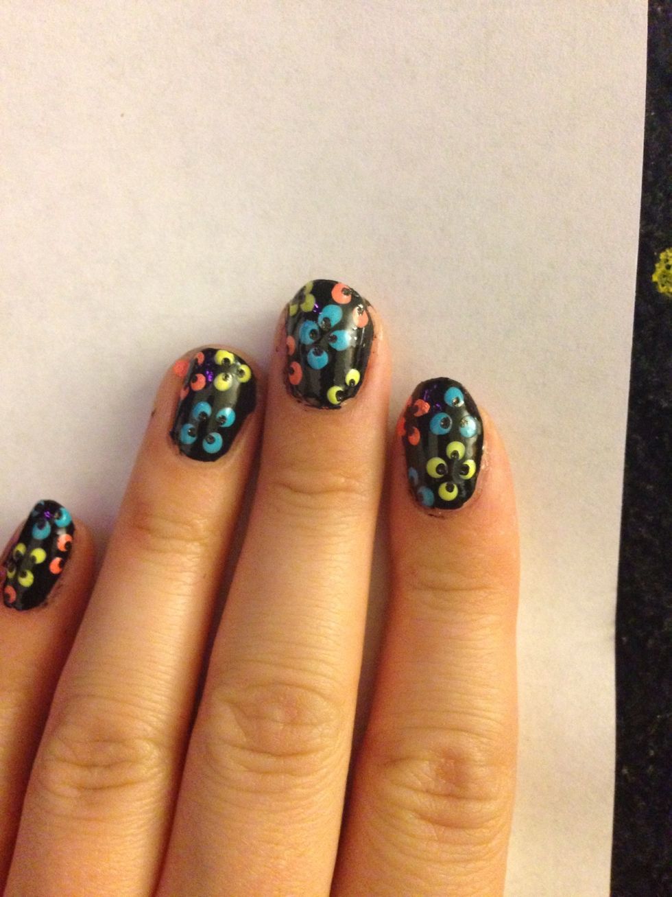 With a toothpick or nail pen, use the same colour as your base colour an do small dots toward the middle of the flower