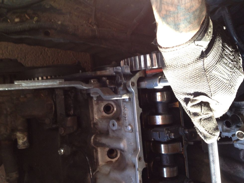 With a Torque wrench, loosen head bolts starting from outside bolts to the center bolts.
