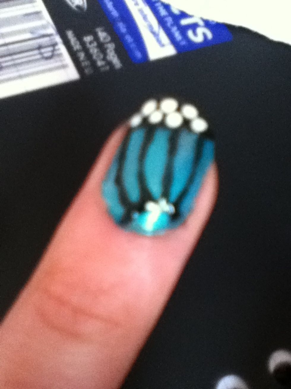 With a white nail art pen add a few small white dots on the black at the top. Done!