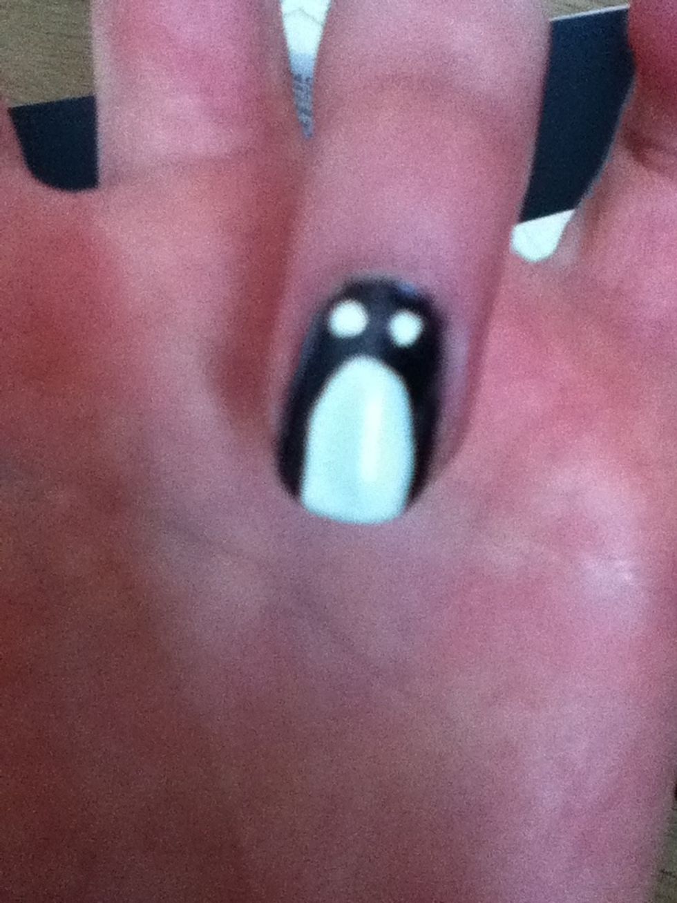 With a white nail art pen or white nail varnish and a pen, draw two dots in the black space above the eye.
