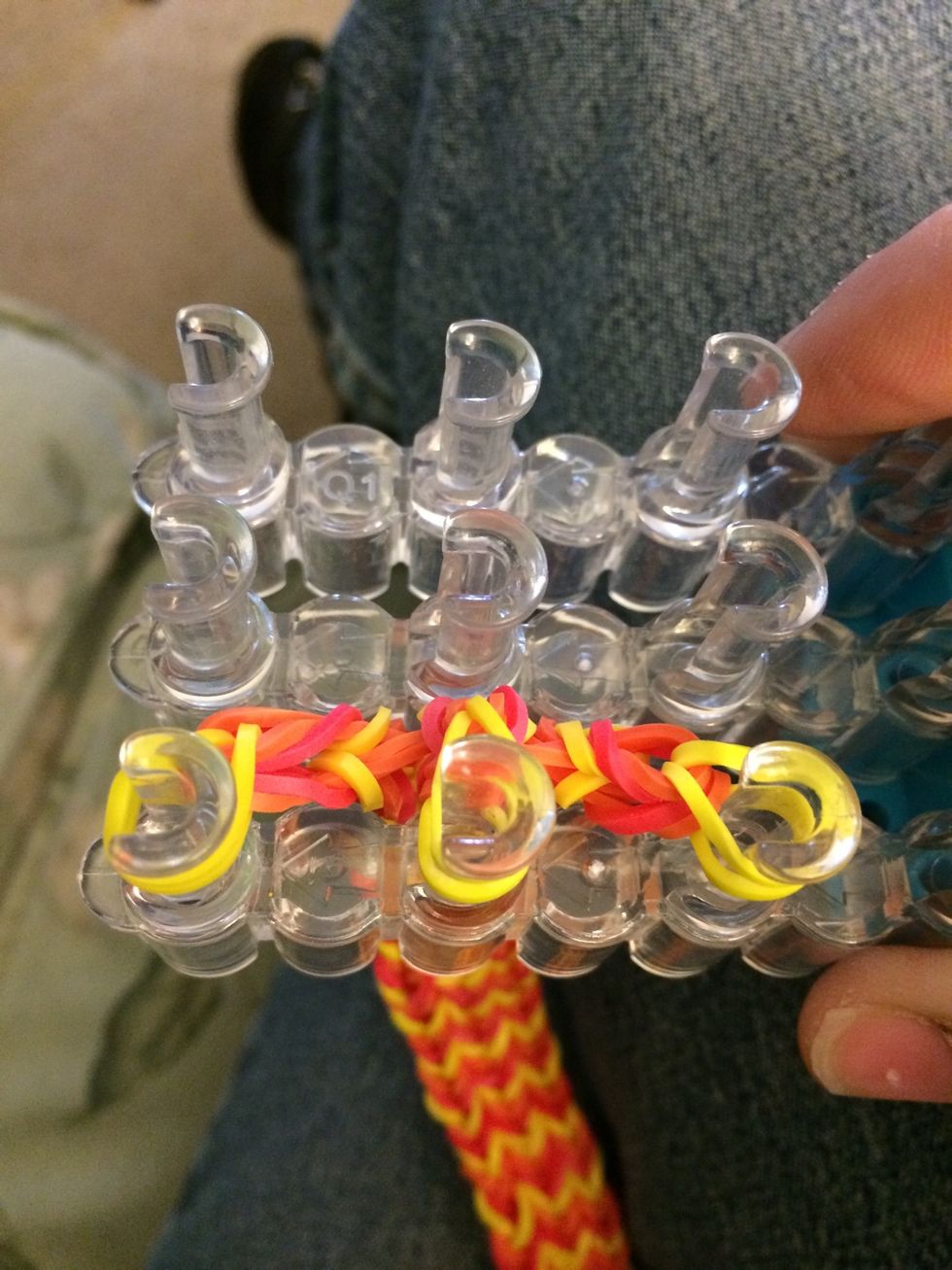 With all the bands on 3 pegs, let's loop the bands over that are on the bottom.