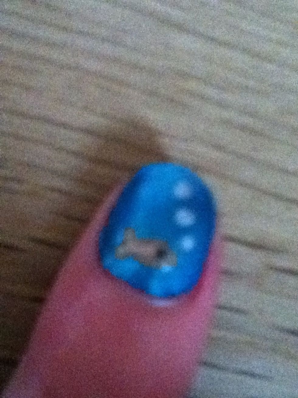 With an orange nail art pen, draw an oval with two flicks coming off at one end on the bottom of the nail, then add a small black dot or an eye. For bubbles, draw three circles in silver. Done!!